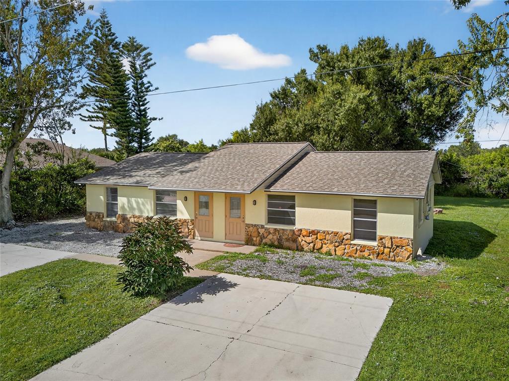 12337 Buffing Road, Unit A AND B Port Charlotte, FL 33981 - Photo 24 of 27 front view of a house with a yard