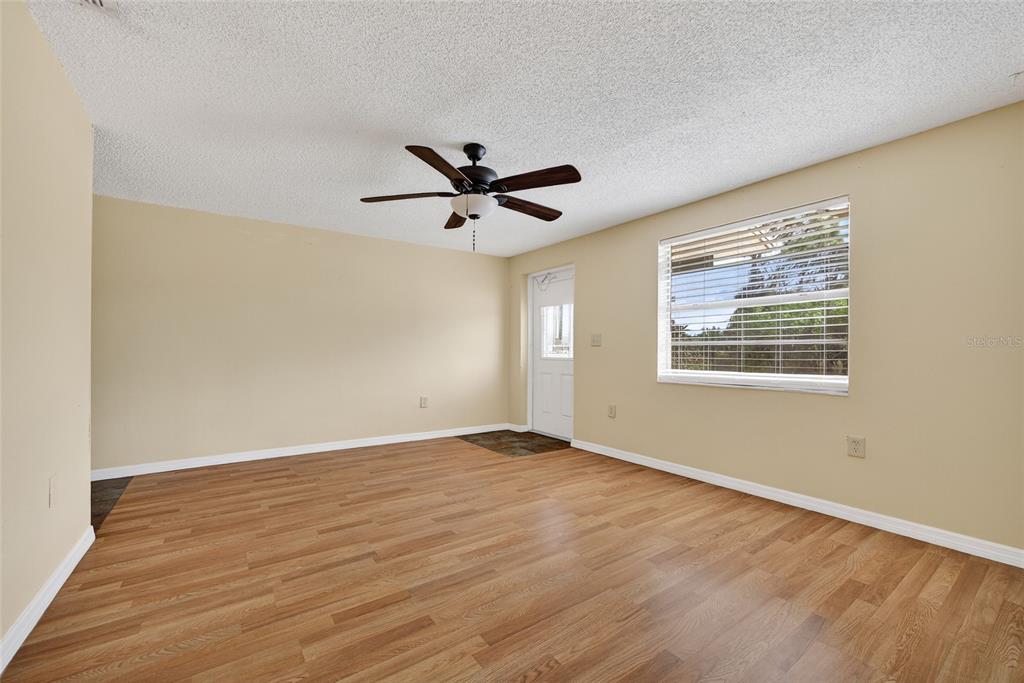 12337 Buffing Road, Unit A AND B Port Charlotte, FL 33981 - Photo 3 of 27 an empty room with wooden floor and windows