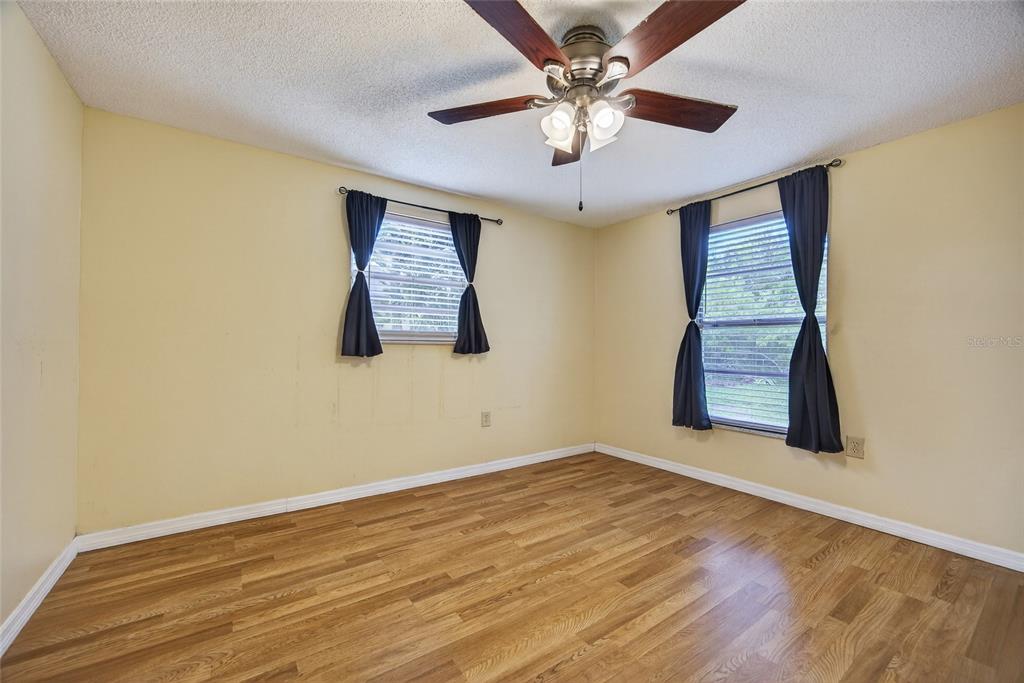 12337 Buffing Road, Unit A AND B Port Charlotte, FL 33981 - Photo 7 of 27 a view of an empty room with a window and wooden floor