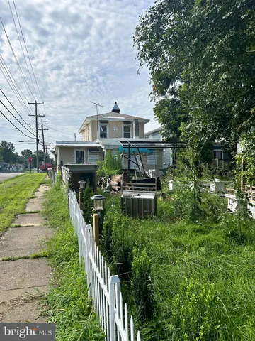 a aerial view of a house with a yard table and chairs