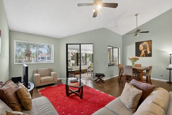 a living room with furniture a rug and a window