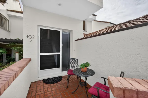 a balcony with table and chairs
