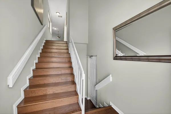 a view of a hallway with wooden floor and closet