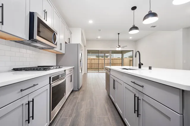 a kitchen with cabinets and stainless steel appliances