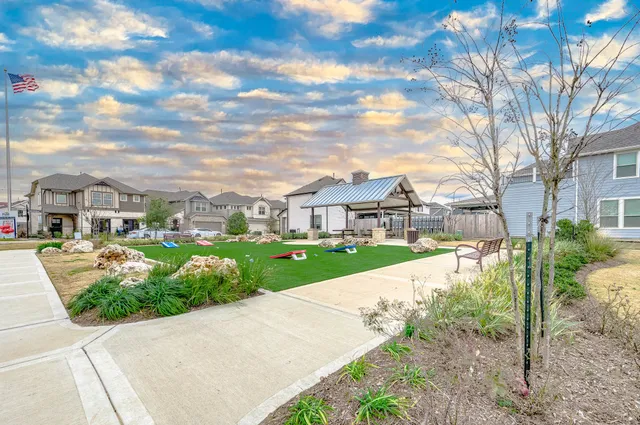 a view of a big yard with a house in the background
