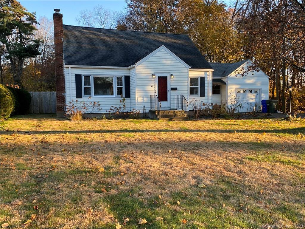 a view of a house with swimming pool and a yard