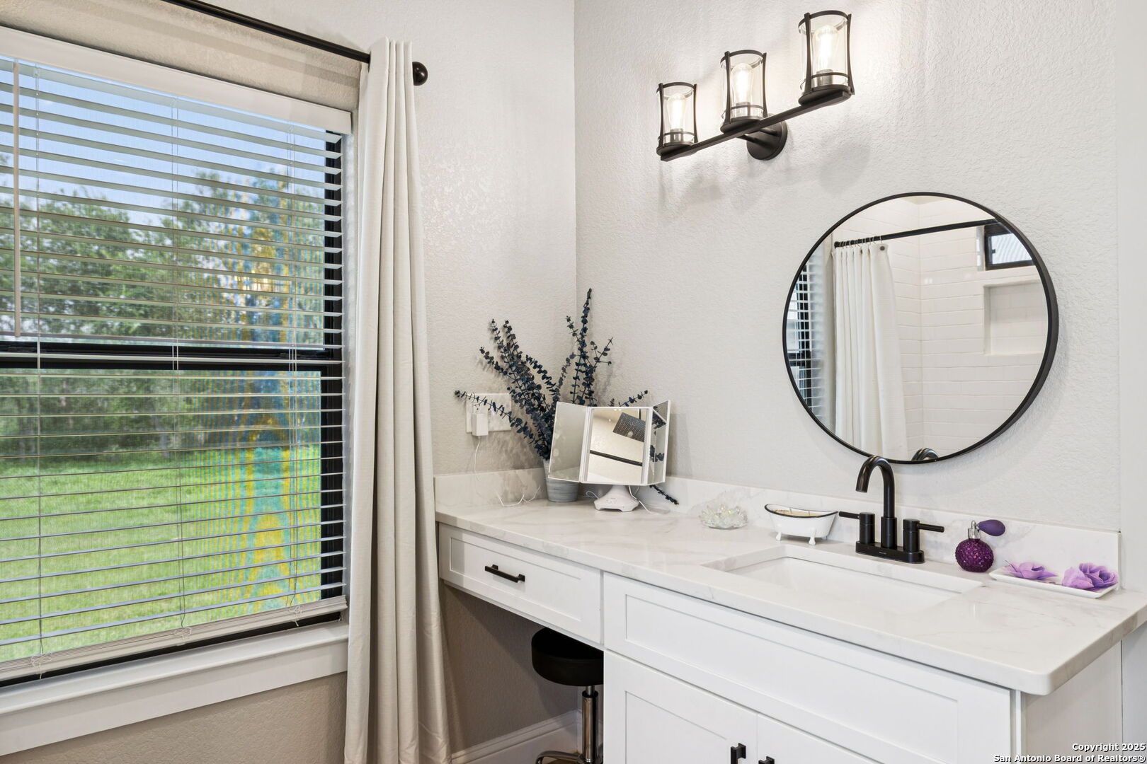 177 East Short Meadow Drive Lytle, TX 78052 - Photo 29 of 63 a bathroom with a sink and a mirror