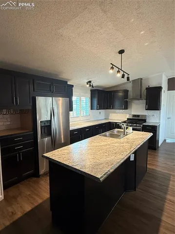 a kitchen with stainless steel appliances granite countertop a stove and a refrigerator