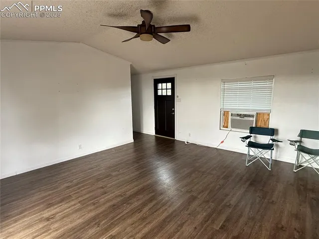 a view of workspace with wooden floor and ceiling fan