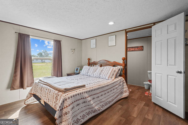 223 Primrose Lane Baxley, GA 31513 - Photo 11 of 27 a bedroom with a bed and a window