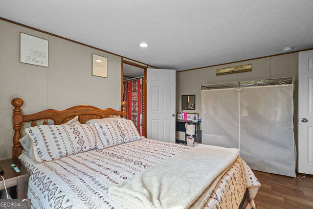 223 Primrose Lane Baxley, GA 31513 - Photo 13 of 27 a bedroom with a bed and a dresser