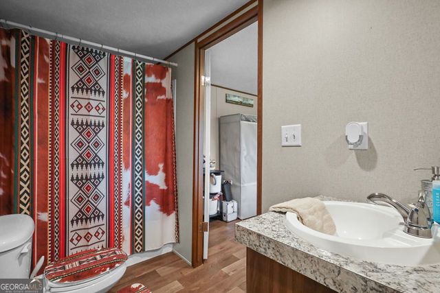 223 Primrose Lane Baxley, GA 31513 - Photo 14 of 27 a bathroom with a sink and a mirror