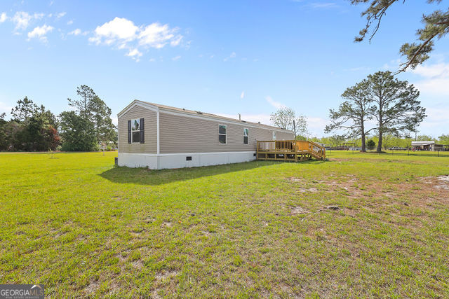 223 Primrose Lane Baxley, GA 31513 - Photo 22 of 27 a view of a house with a big yard
