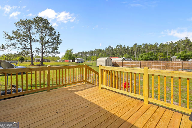223 Primrose Lane Baxley, GA 31513 - Photo 27 of 27 a view of a balcony with wooden floor and fence