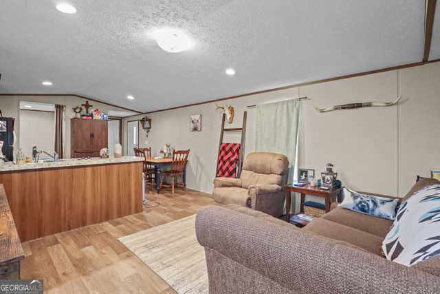 223 Primrose Lane Baxley, GA 31513 - Photo 3 of 27 a living room with furniture and a large window