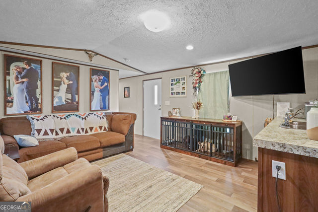 223 Primrose Lane Baxley, GA 31513 - Photo 4 of 27 a bedroom with furniture and a flat screen tv