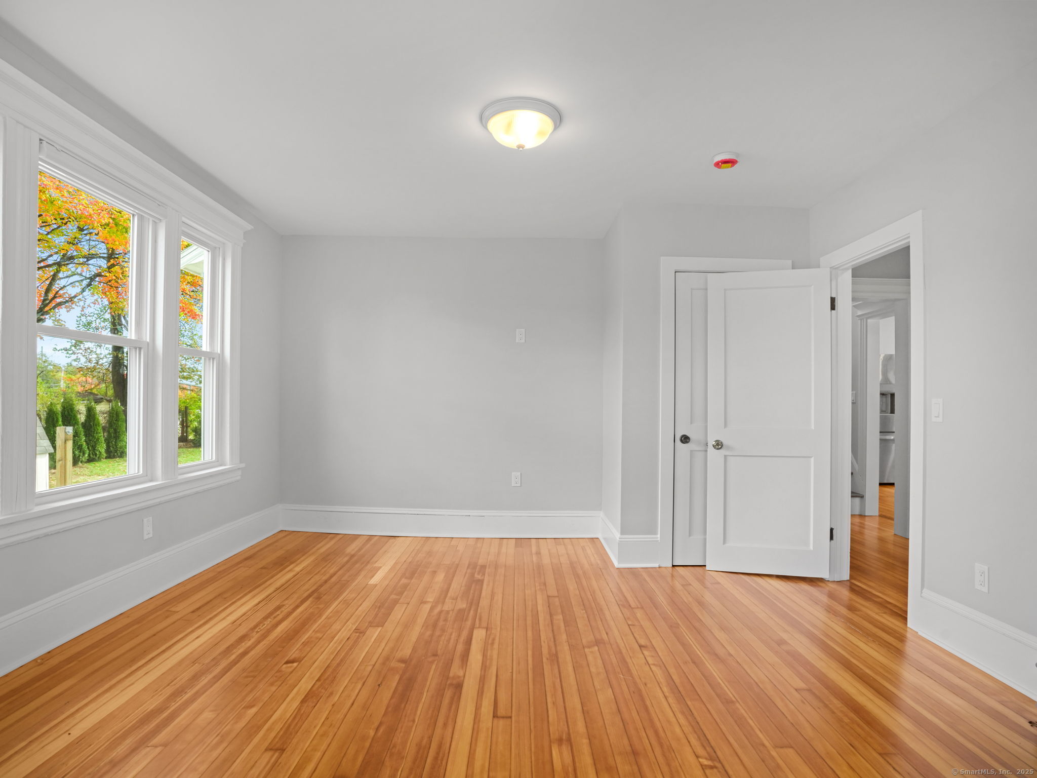 29 Redfield Road Fairfield, CT 06824 - Photo 14 of 37 a view of empty room with wooden floor and fan