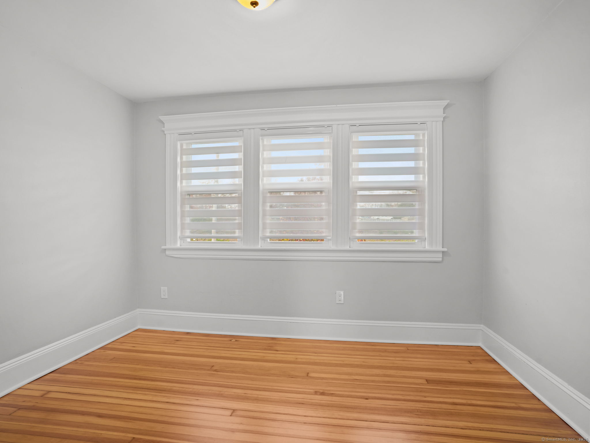 29 Redfield Road Fairfield, CT 06824 - Photo 15 of 37 wooden floor in an empty room with a window