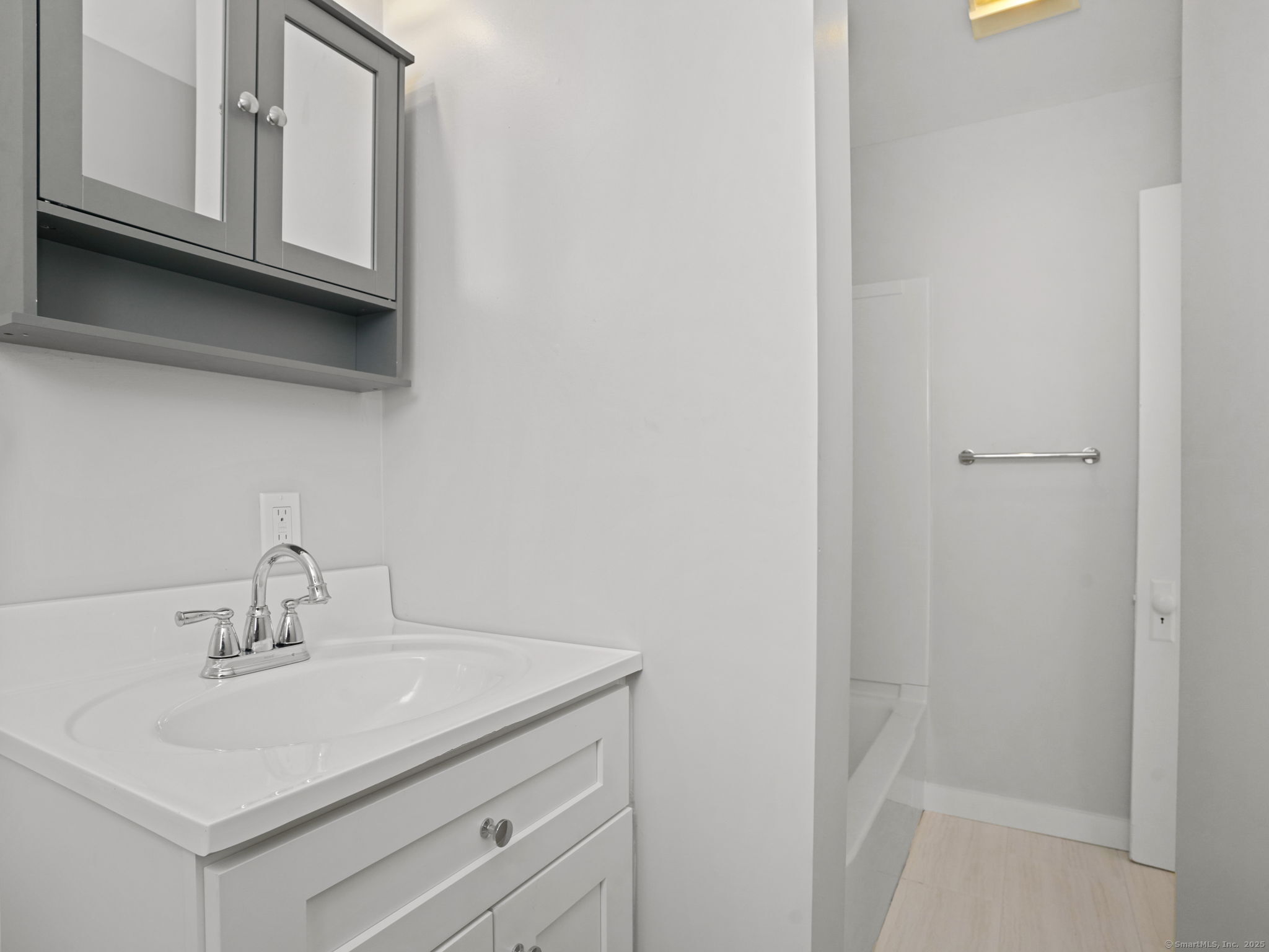 29 Redfield Road Fairfield, CT 06824 - Photo 17 of 37 a bathroom with a sink a vanity and a mirror