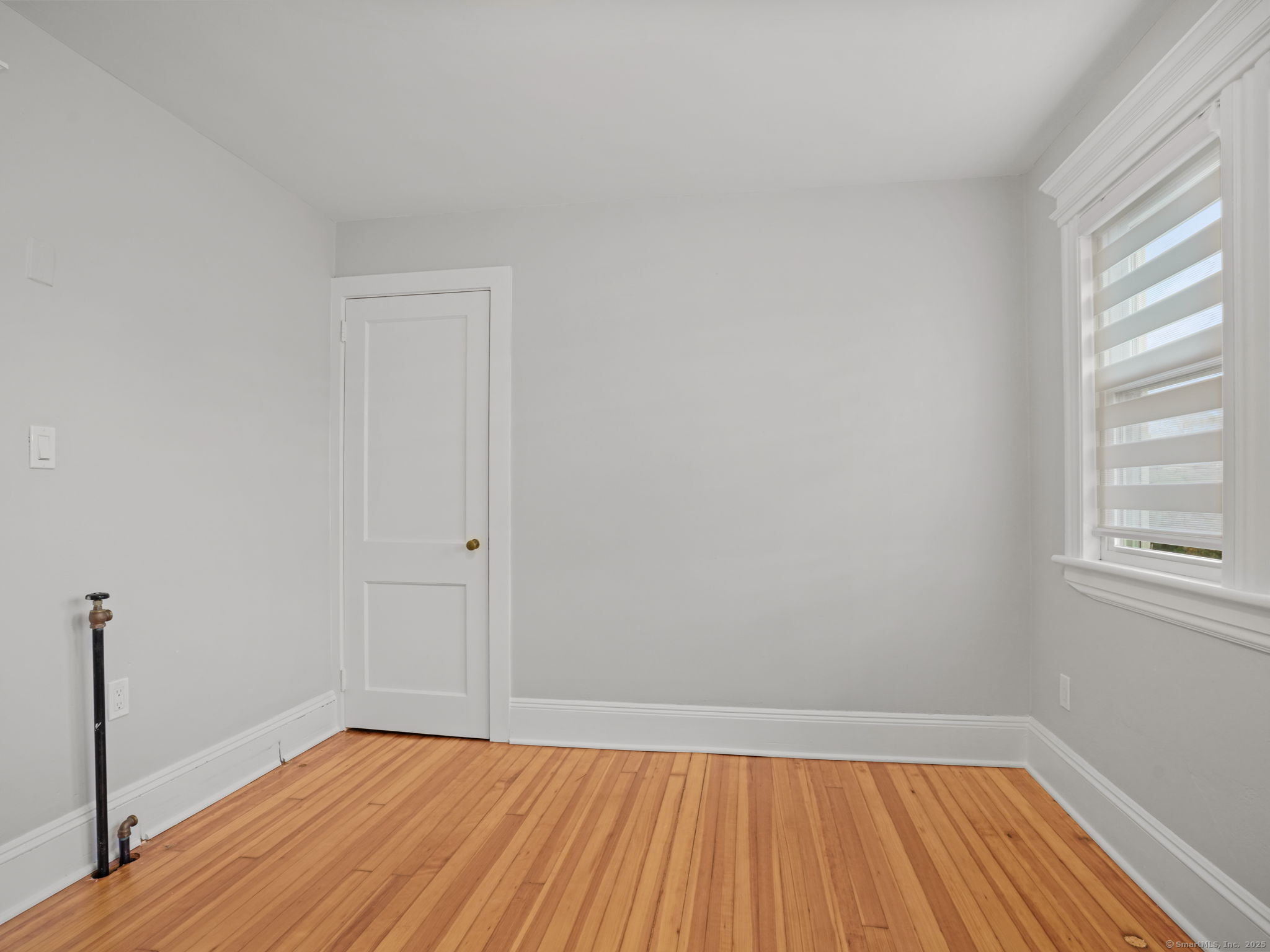 29 Redfield Road Fairfield, CT 06824 - Photo 20 of 37 a view of a room with wooden floor and window