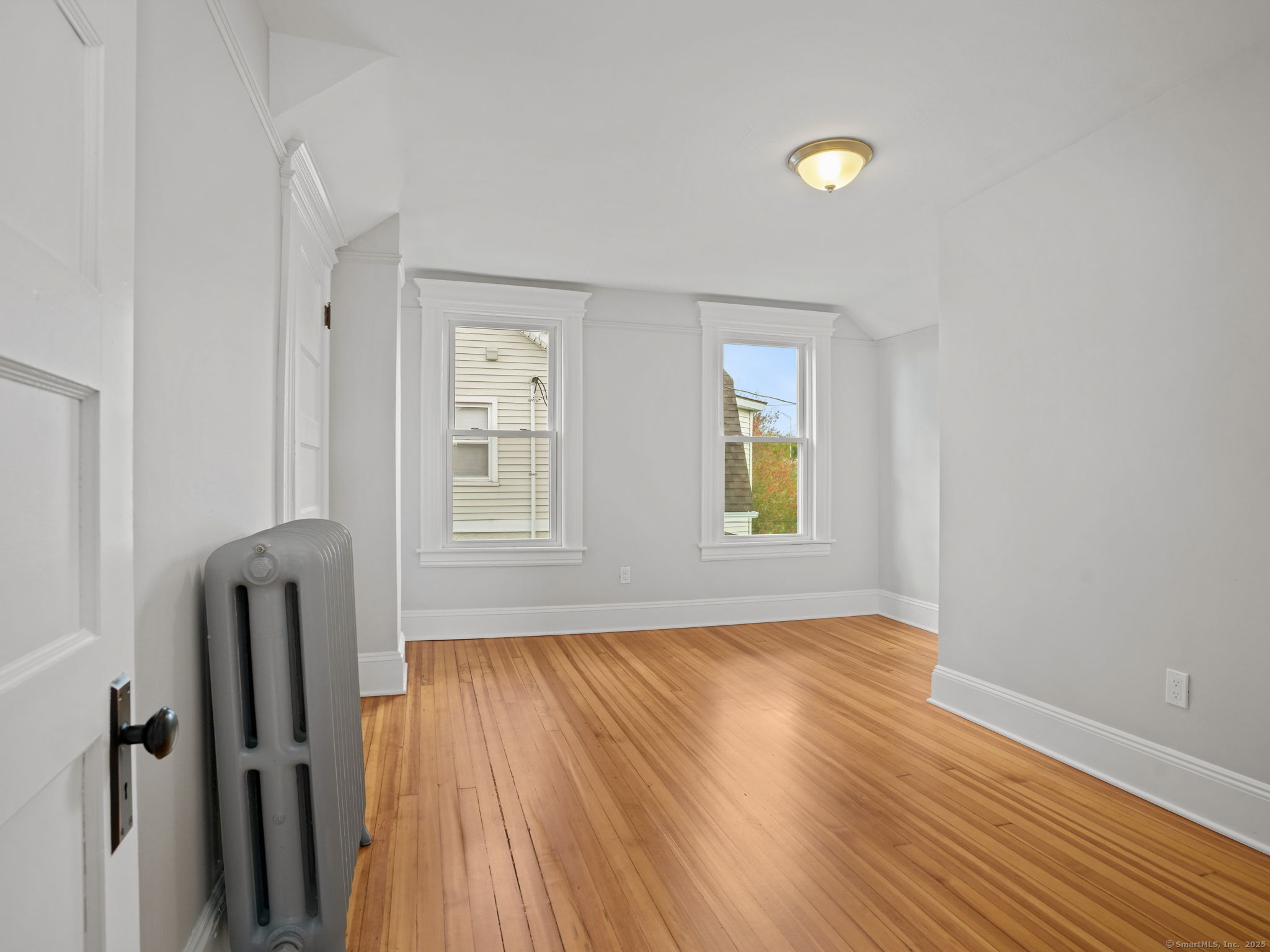 29 Redfield Road Fairfield, CT 06824 - Photo 21 of 37 a view of an empty room with wooden floor and a window