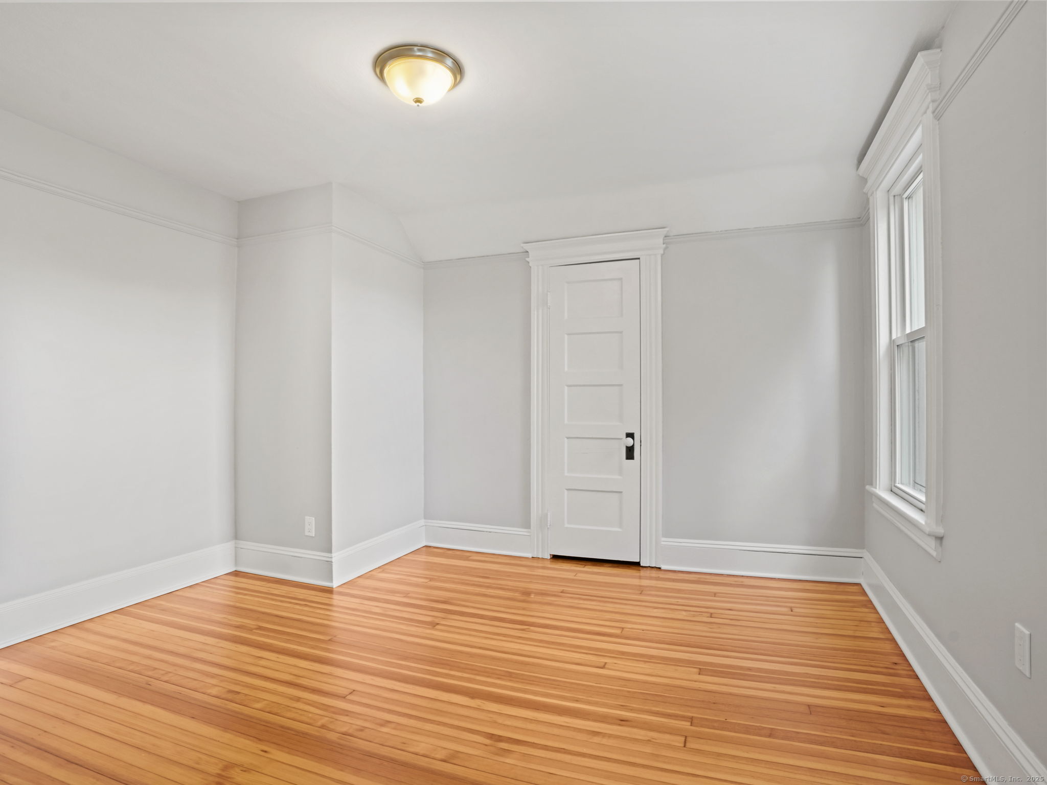 29 Redfield Road Fairfield, CT 06824 - Photo 25 of 37 a view of empty room with wooden floor and fan