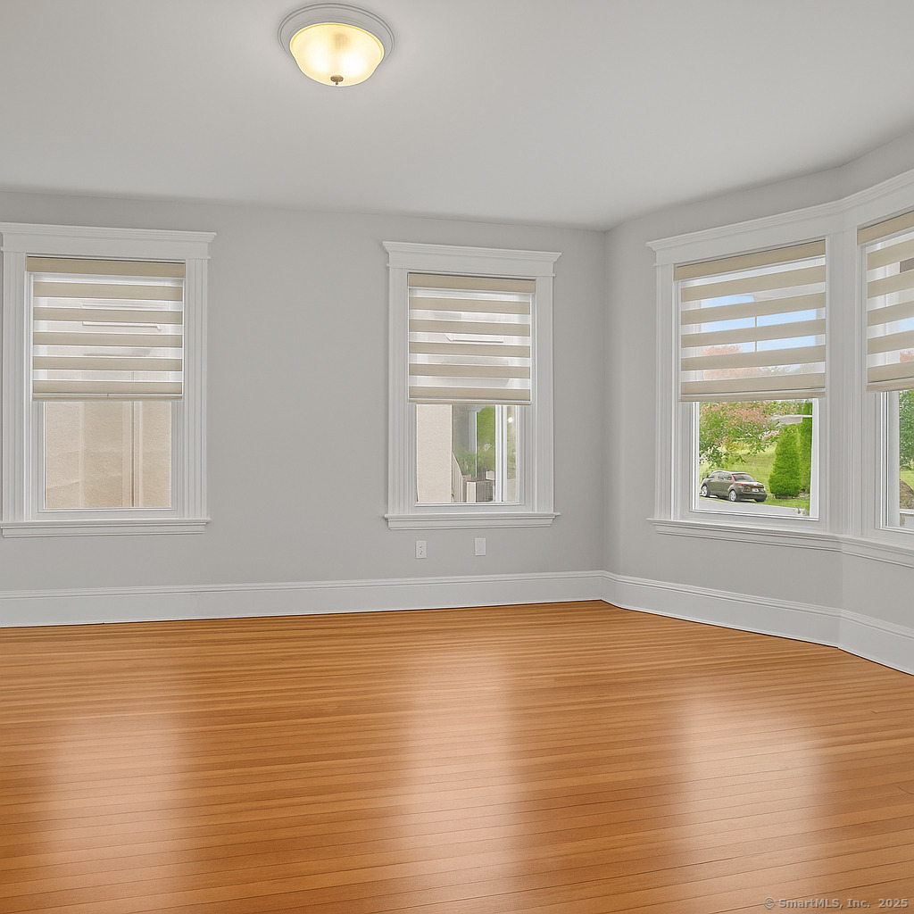 29 Redfield Road Fairfield, CT 06824 - Photo 3 of 37 a view of an empty room with wooden floor and a window