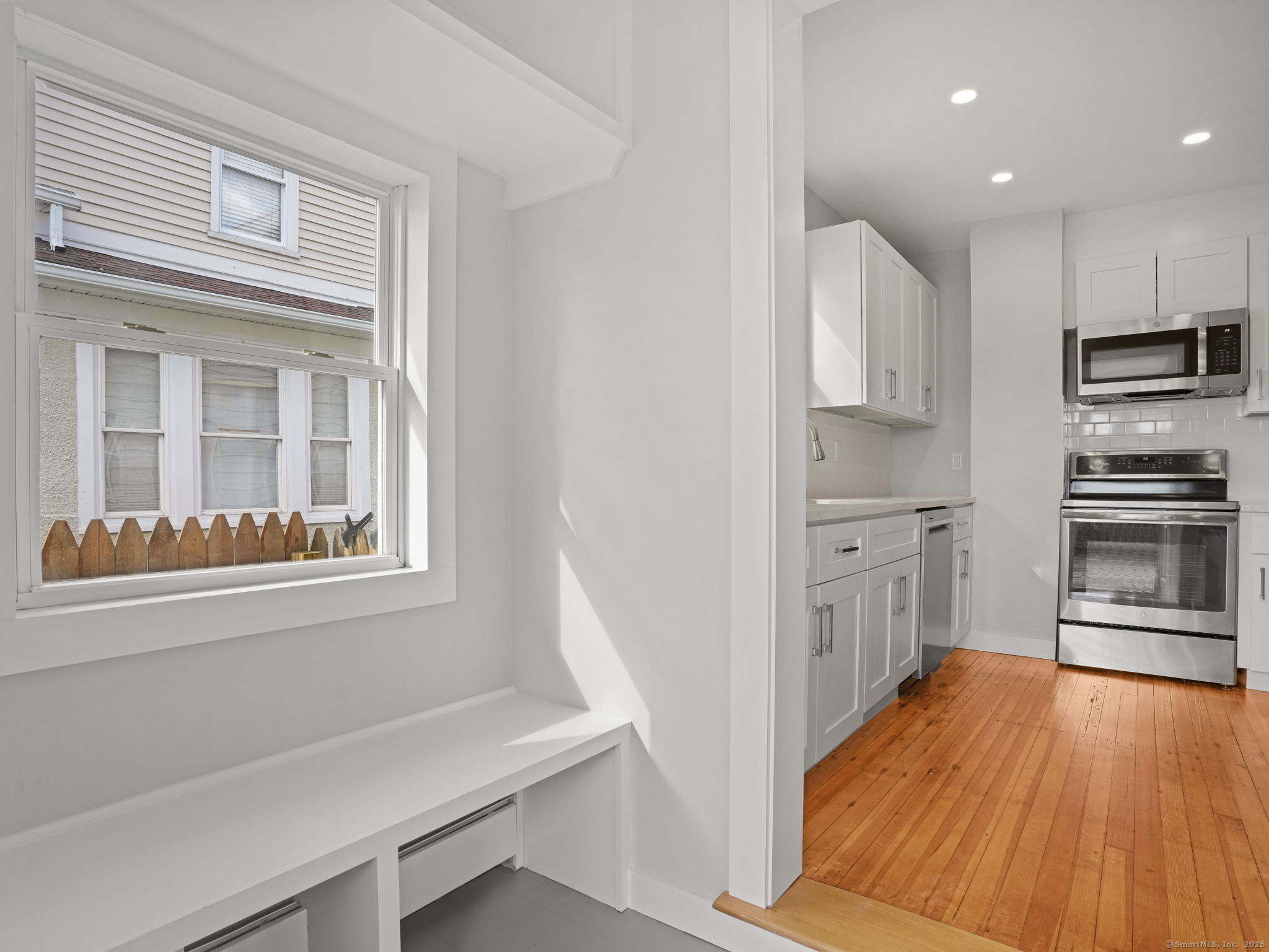 29 Redfield Road Fairfield, CT 06824 - Photo 9 of 37 a kitchen with stainless steel appliances a refrigerator and a stove top oven