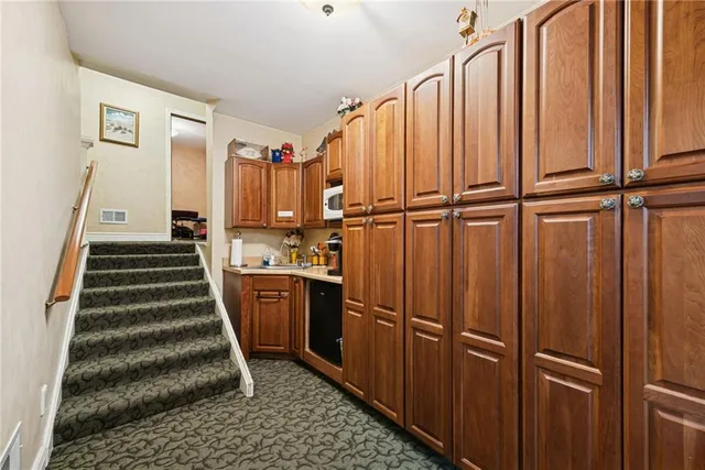 a view of a kitchen with storage and utility room