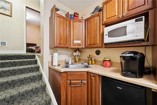 a utility room with sink dryer and washer
