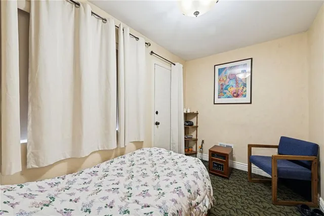 a bedroom with a bed a desk and chair