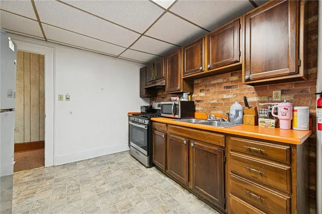 a kitchen with stainless steel appliances granite countertop a refrigerator stove and sink