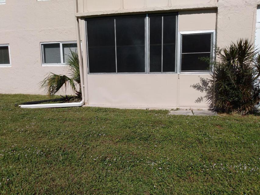 225 Bonnie Boulevard, Unit 109 Palm Springs, FL 33461 - Photo 3 of 5 a front view of a house with garden