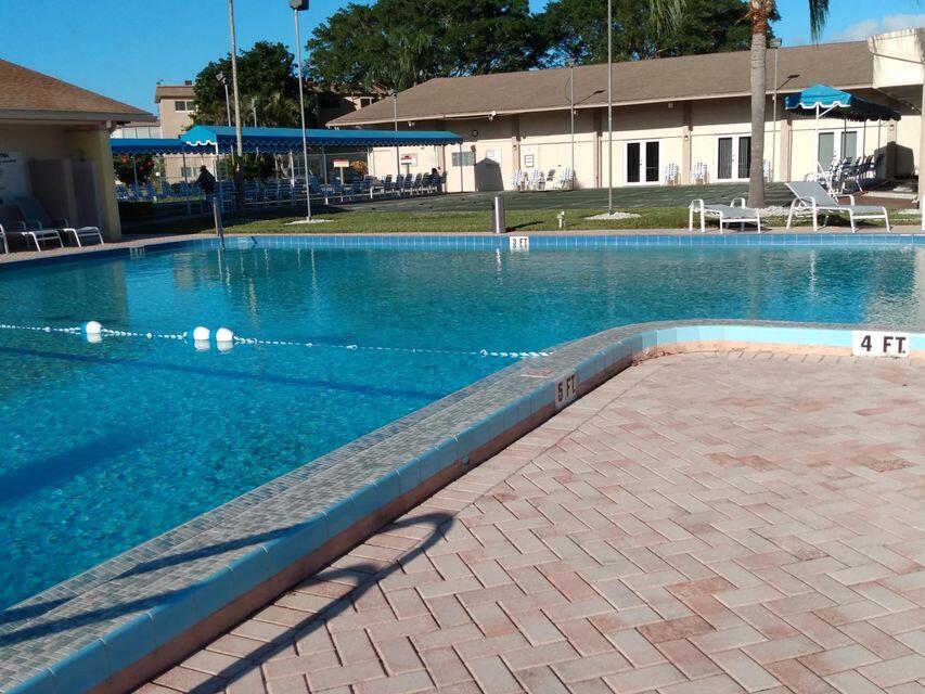 225 Bonnie Boulevard, Unit 109 Palm Springs, FL 33461 - Photo 4 of 5 swimming pool view with a outdoor seating