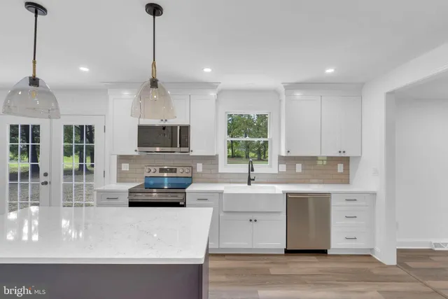 a view of empty room with wooden floor and window