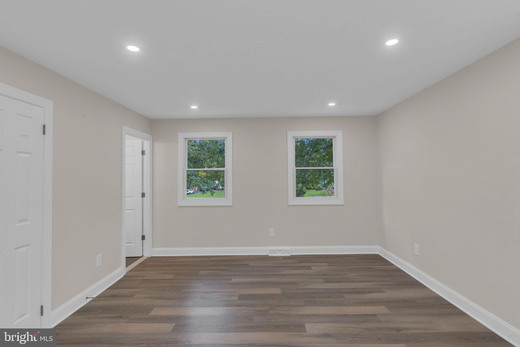 5925 Corrigan Road Doylestown, PA 18902 - Photo 26 of 64 an empty room with wooden floor and windows