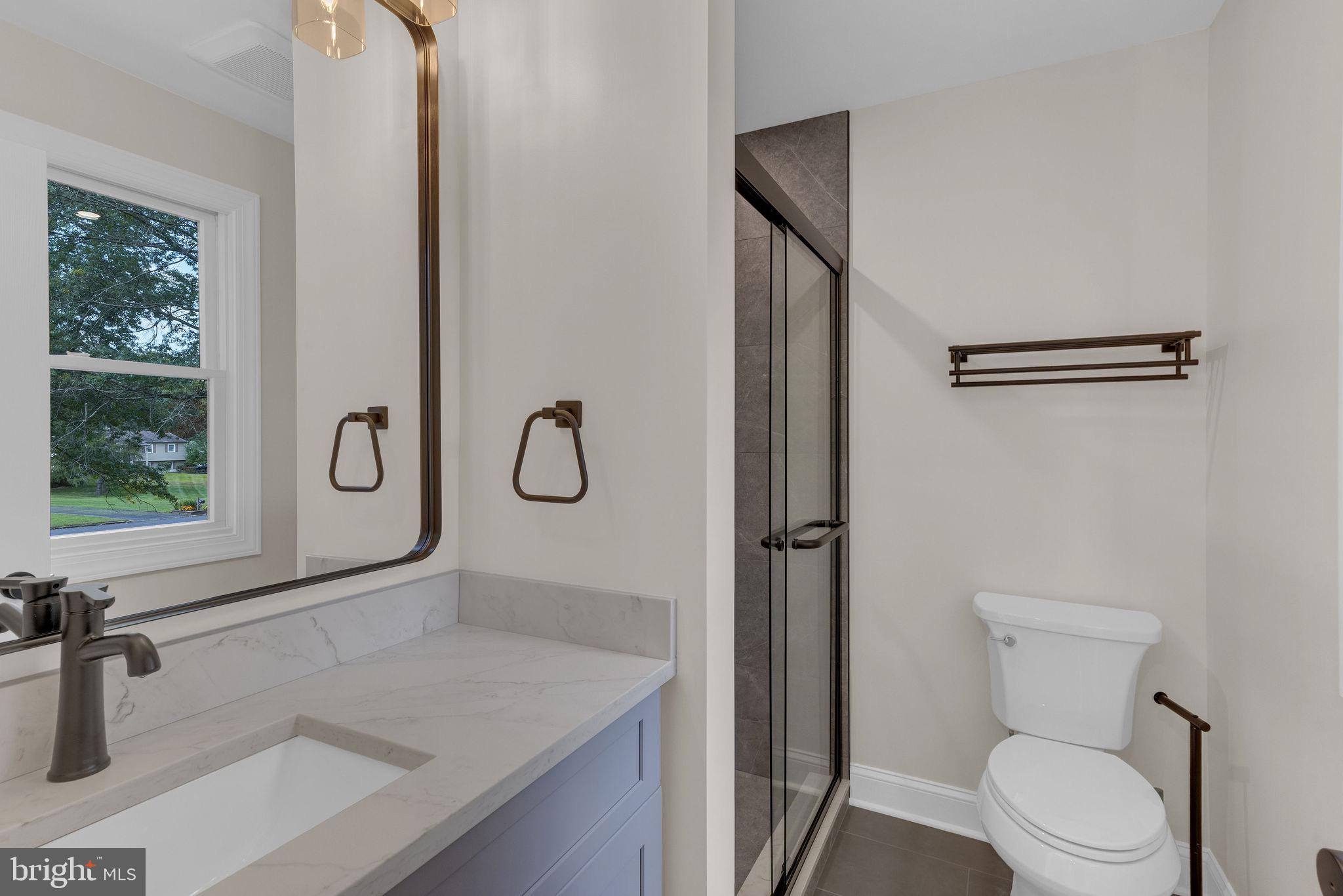 5925 Corrigan Road Doylestown, PA 18902 - Photo 27 of 64 a bathroom with a granite countertop sink toilet and shower