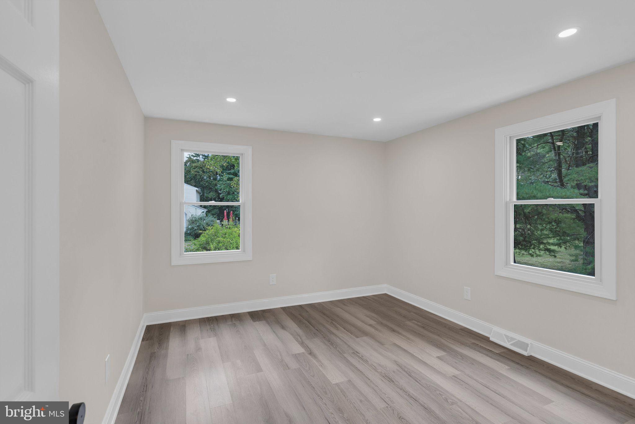 5925 Corrigan Road Doylestown, PA 18902 - Photo 29 of 64 an empty room with wooden floor and windows