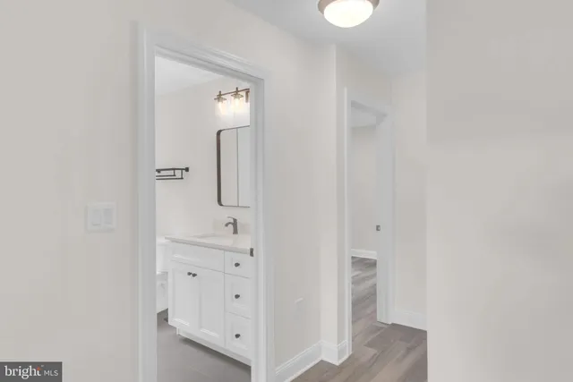 a view of a room with wooden floor and windows