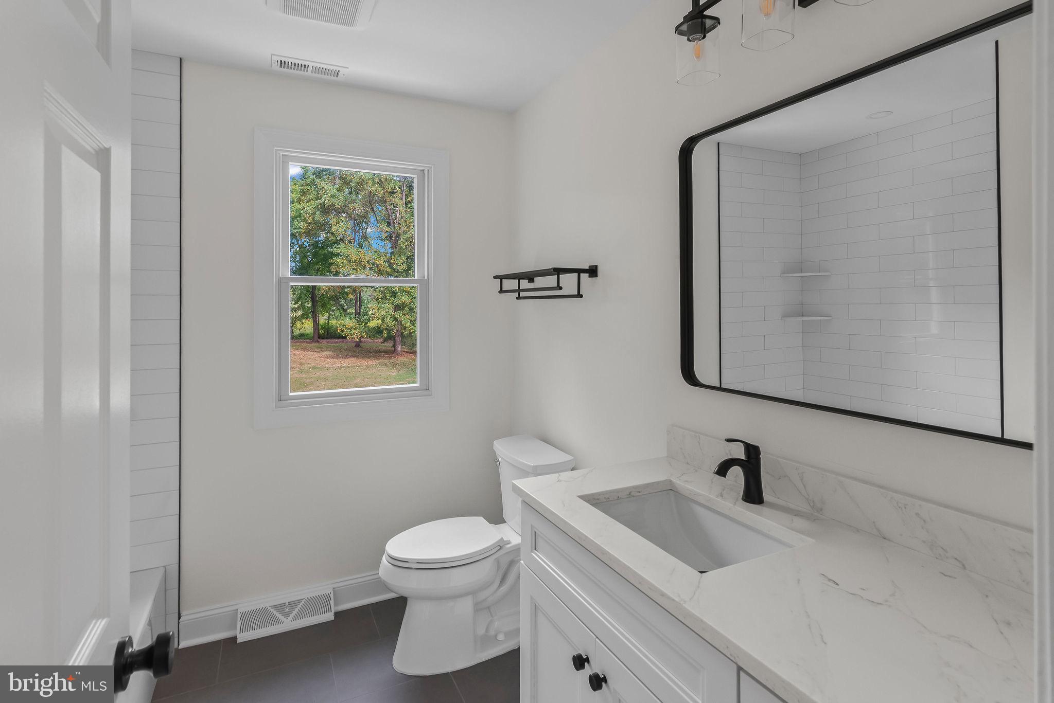 5925 Corrigan Road Doylestown, PA 18902 - Photo 31 of 64 a bathroom with a sink a toilet and mirror