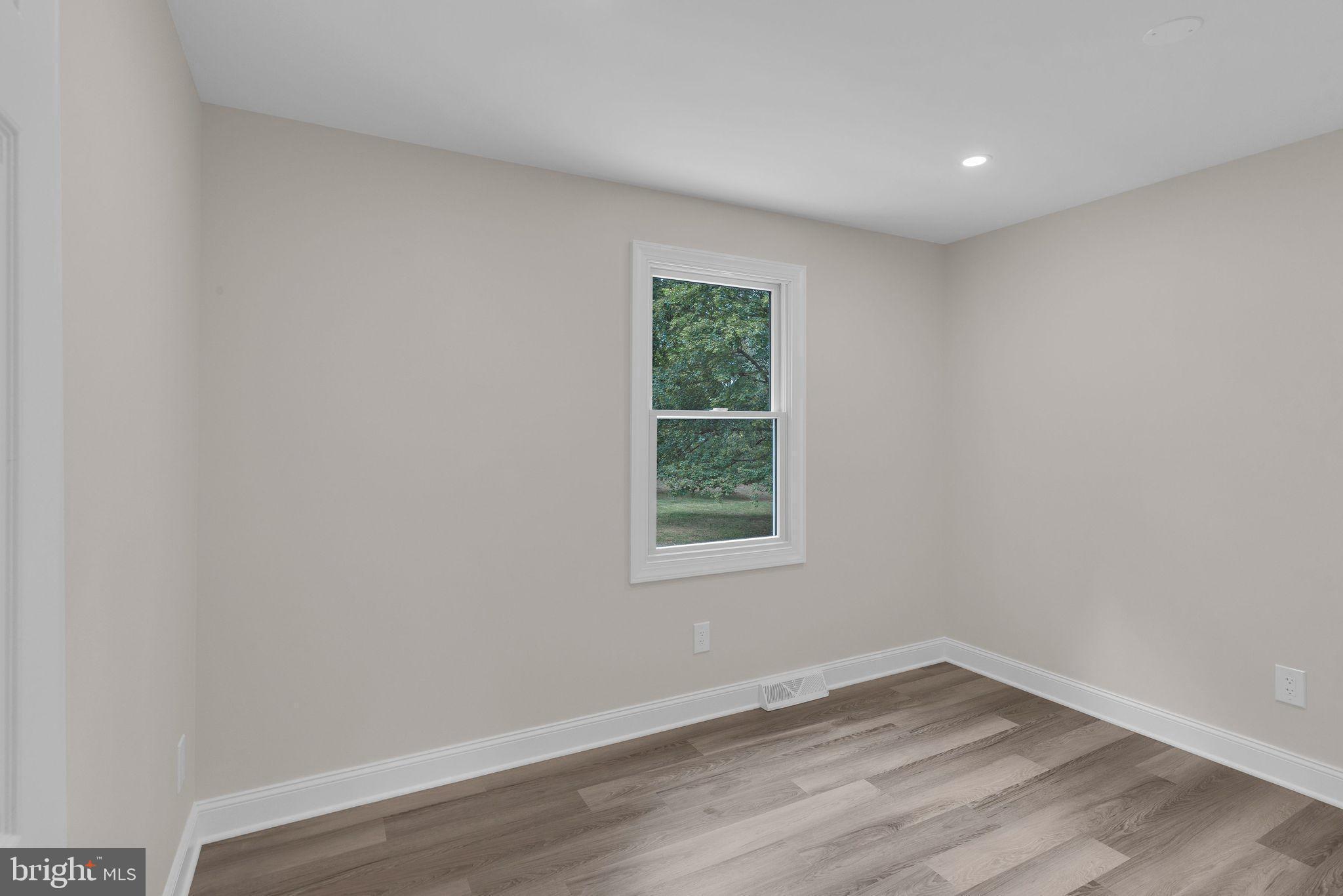 5925 Corrigan Road Doylestown, PA 18902 - Photo 34 of 64 a view of an empty room with wooden floor and a window