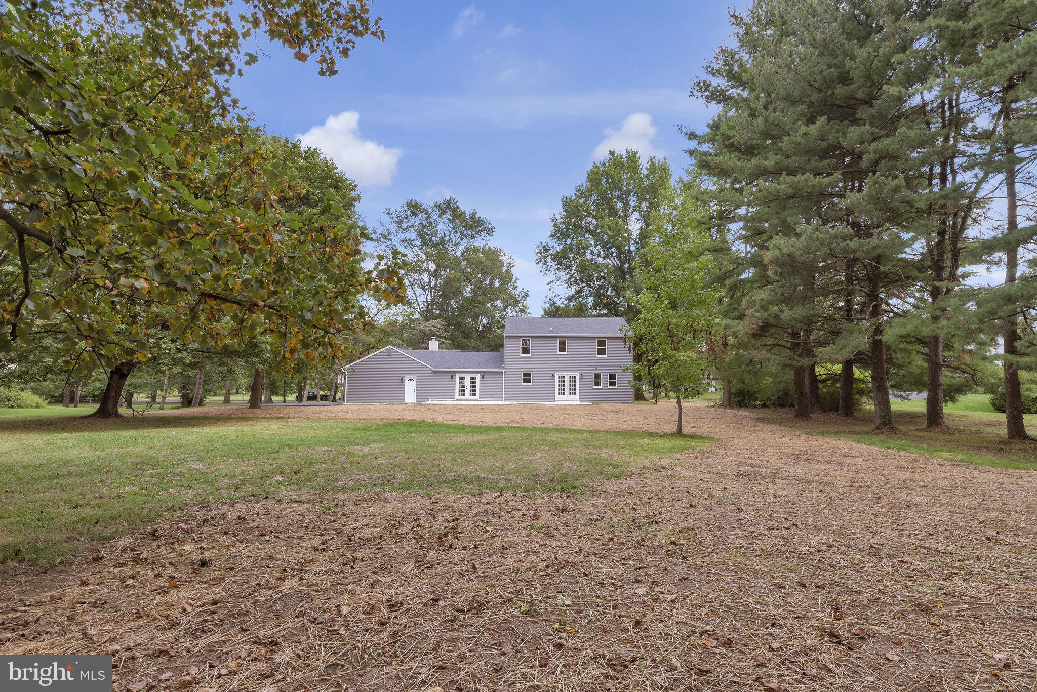 5925 Corrigan Road Doylestown, PA 18902 - Photo 47 of 64 a big house with trees in front of it