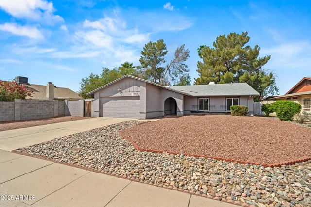 a front view of house with a garden