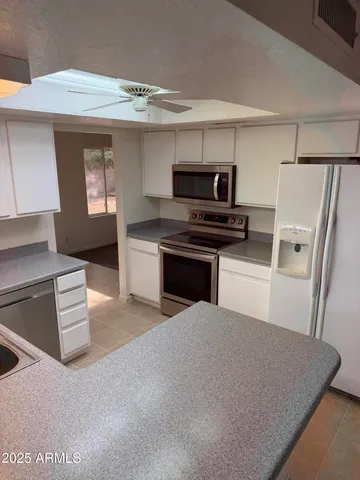a kitchen with stainless steel appliances a stove a sink and a refrigerator