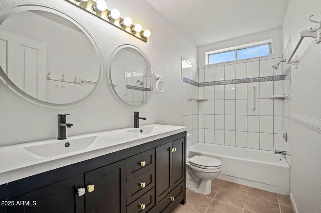 a bathroom with a toilet a sink a mirror and bathtub