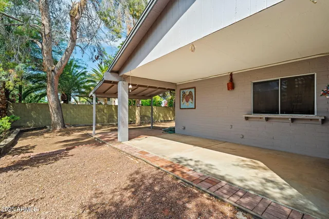 a backyard of a house with basket ball court and outdoor seating