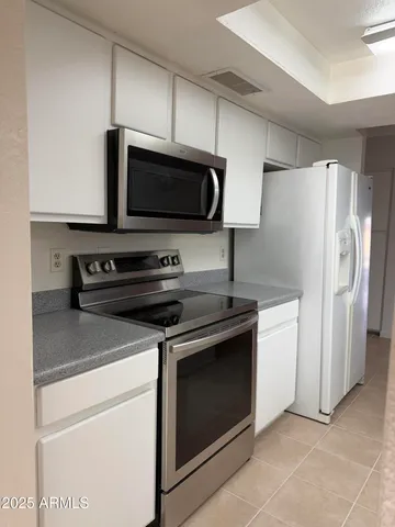 a kitchen with stainless steel appliances a stove a microwave and a refrigerator