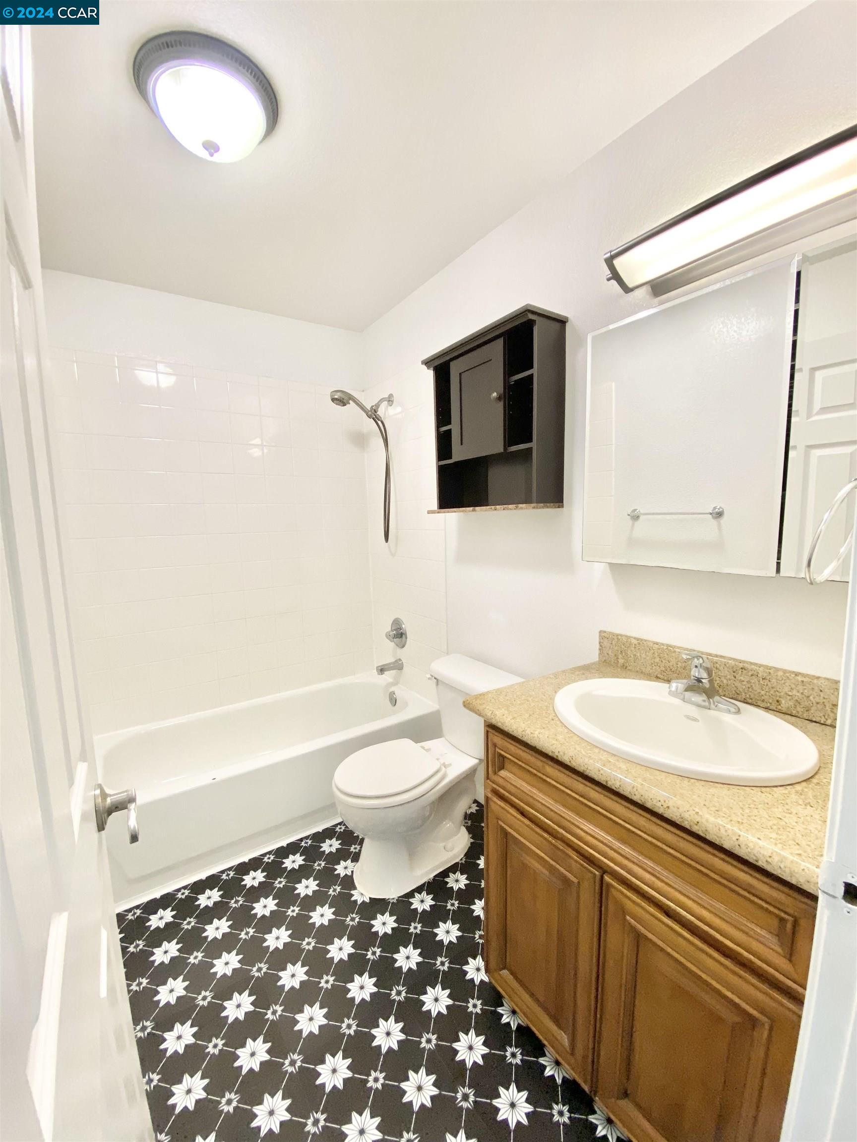 222 Piedmont Lane Pittsburg, CA 94565 - Photo 14 of 25 a bathroom with a sink a toilet a mirror and shower
