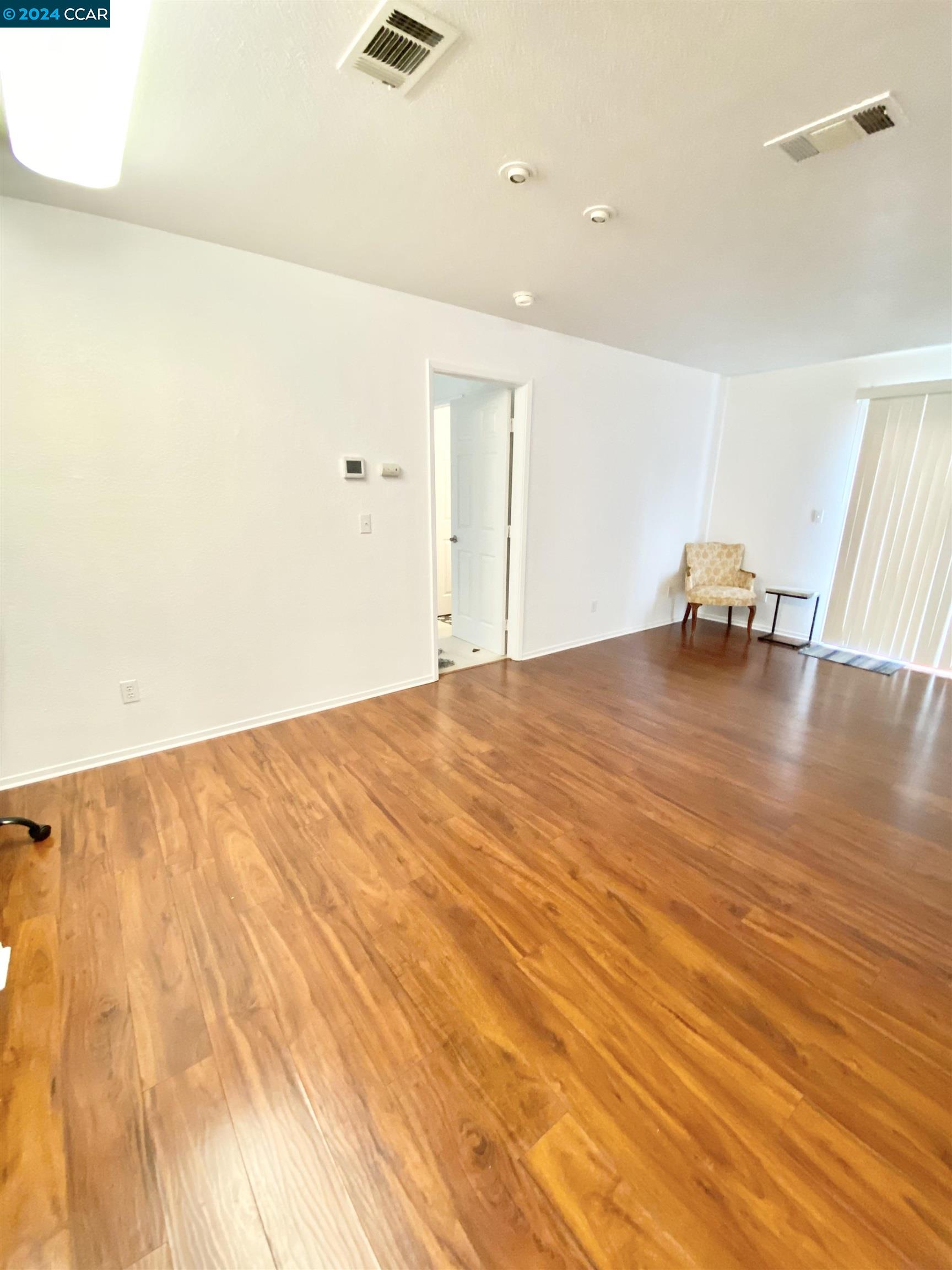 222 Piedmont Lane Pittsburg, CA 94565 - Photo 6 of 25 a big room with wooden floor