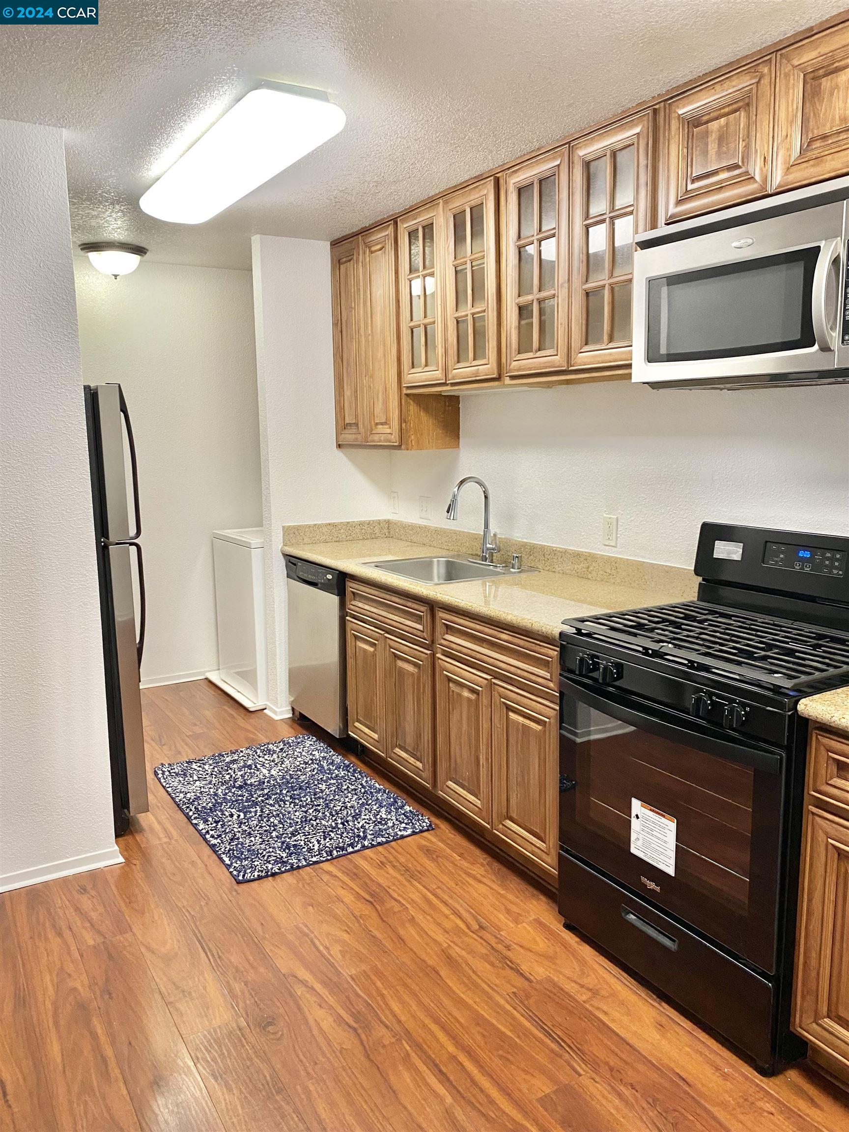 222 Piedmont Lane Pittsburg, CA 94565 - Photo 8 of 25 a kitchen with stainless steel appliances granite countertop a stove and a sink